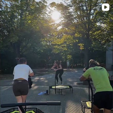Jumping fitness session outdoors between the trees